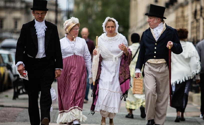 People in costume taking part in the Jane Austen Festival promenade